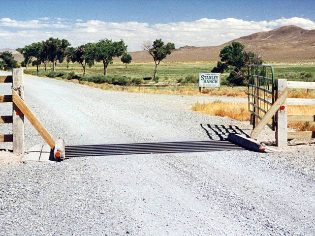 The cattle guard entrance to ranch.